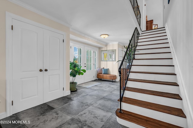 foyer with stairway, french doors, and crown molding