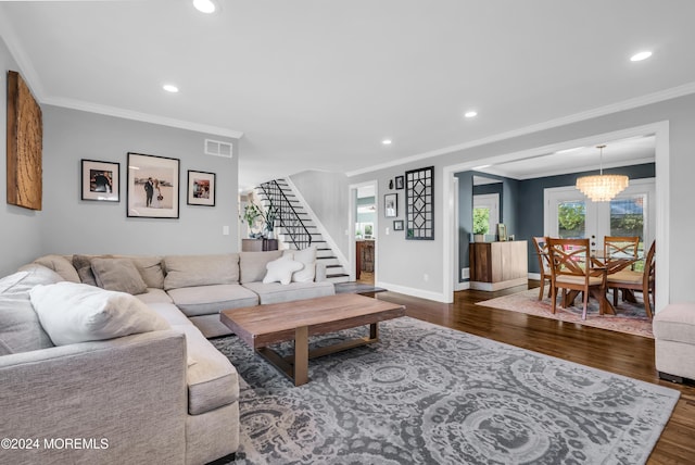 living area with wood finished floors, recessed lighting, stairway, baseboards, and a chandelier