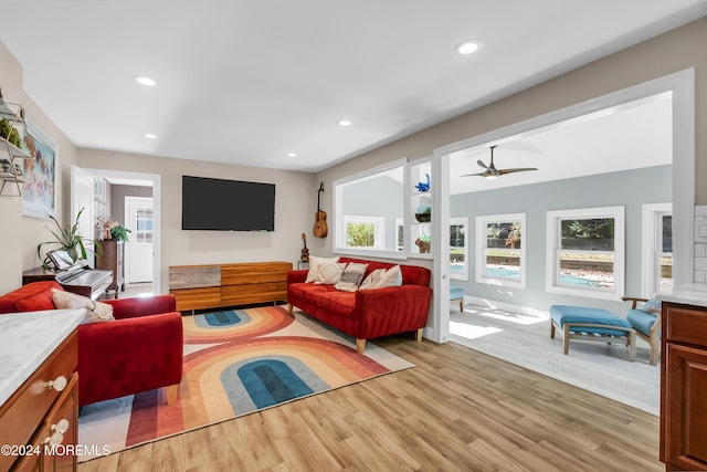 living room with recessed lighting, light wood-style floors, and a ceiling fan