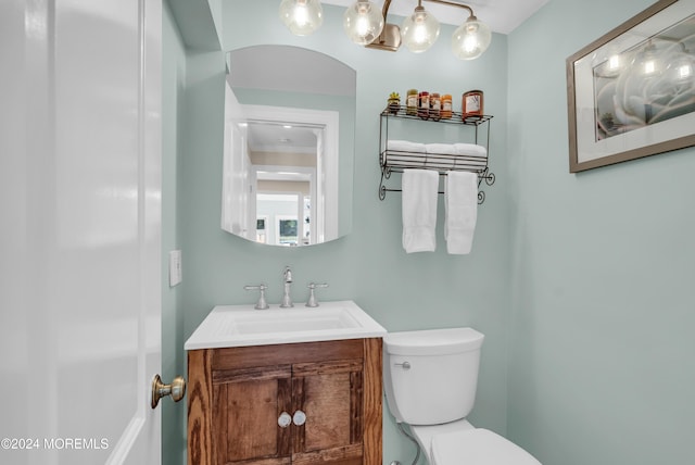 bathroom featuring toilet and vanity