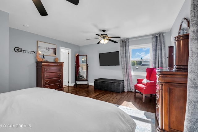 bedroom with baseboards, dark wood-style flooring, and ceiling fan