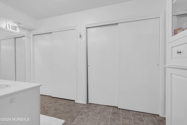 interior space with tile patterned floors and visible vents