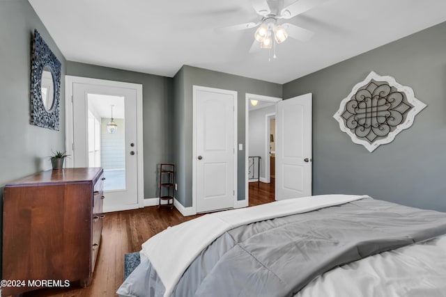 bedroom with dark wood-type flooring, baseboards, and ceiling fan