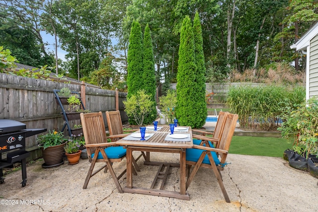 view of patio / terrace with outdoor dining area and a fenced backyard