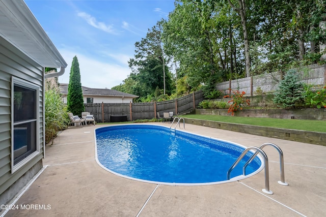 view of swimming pool featuring a fenced backyard, a fenced in pool, and a patio