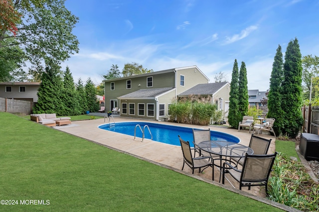 view of swimming pool with fence, a yard, a patio area, and a fenced in pool