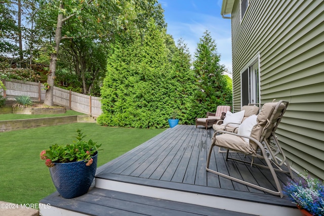 deck with a yard and fence