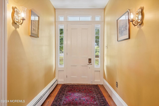 doorway to outside with a baseboard radiator, light wood-style floors, and baseboards