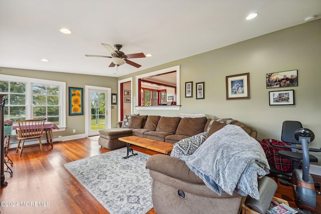 living area featuring a baseboard radiator, recessed lighting, ceiling fan, and wood finished floors