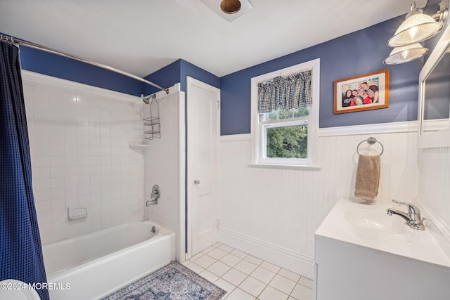 bathroom featuring shower / bath combination with curtain, vanity, tile patterned flooring, and a wainscoted wall