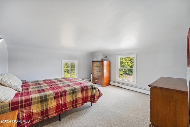 carpeted bedroom with a baseboard heating unit