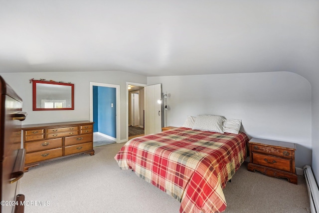 bedroom featuring carpet flooring, a baseboard radiator, and vaulted ceiling