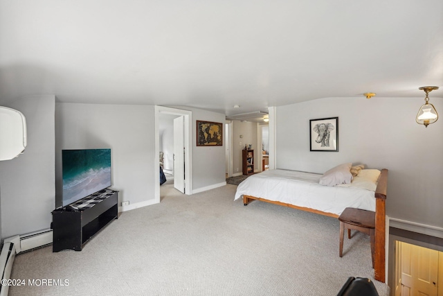 carpeted bedroom featuring ensuite bathroom and baseboards
