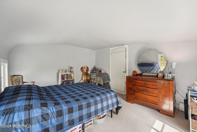 carpeted bedroom featuring lofted ceiling