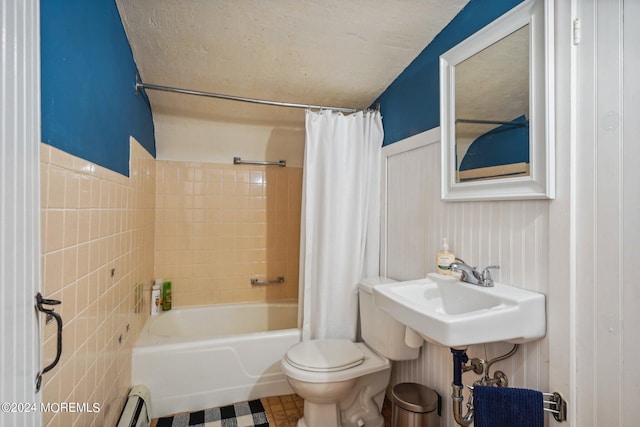 full bathroom featuring toilet, shower / bathtub combination with curtain, and a sink