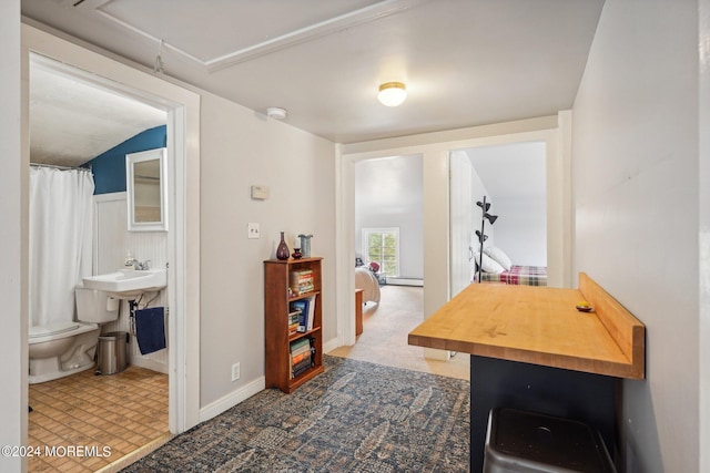 interior space with a baseboard heating unit and attic access