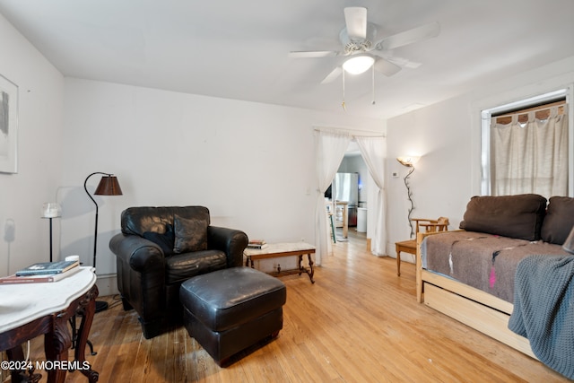 living room featuring light hardwood / wood-style floors and ceiling fan