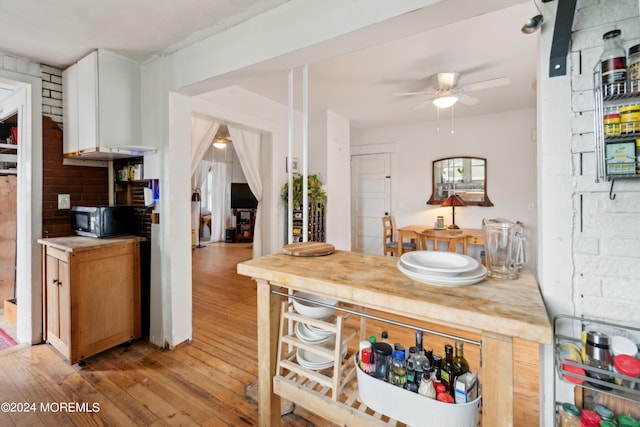 kitchen featuring ceiling fan, light hardwood / wood-style flooring, and white cabinetry