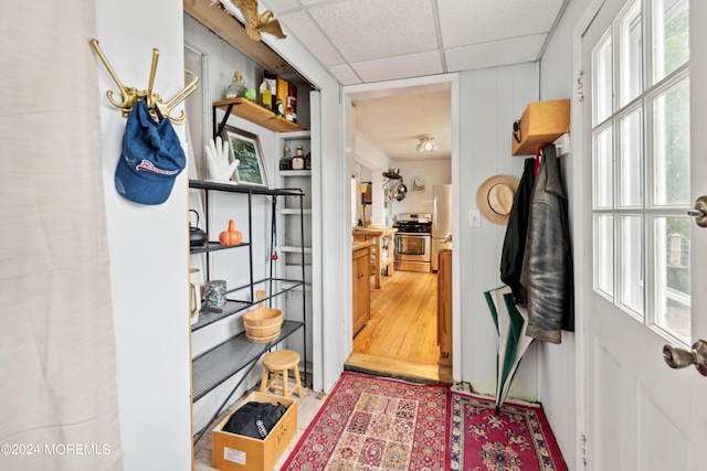 interior space with wood-type flooring and a drop ceiling