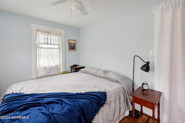 bedroom with ceiling fan and dark hardwood / wood-style flooring