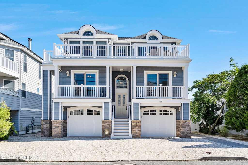 view of front of home featuring a balcony and a garage