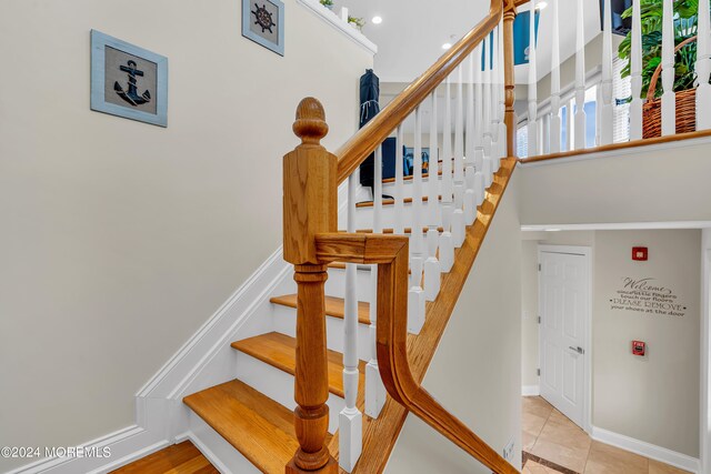 staircase featuring tile patterned floors