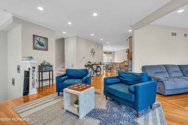 living room with hardwood / wood-style flooring and crown molding