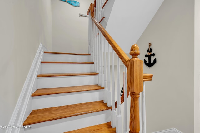 stairs featuring hardwood / wood-style floors