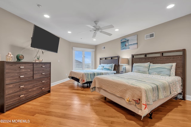 bedroom with ceiling fan and light hardwood / wood-style floors