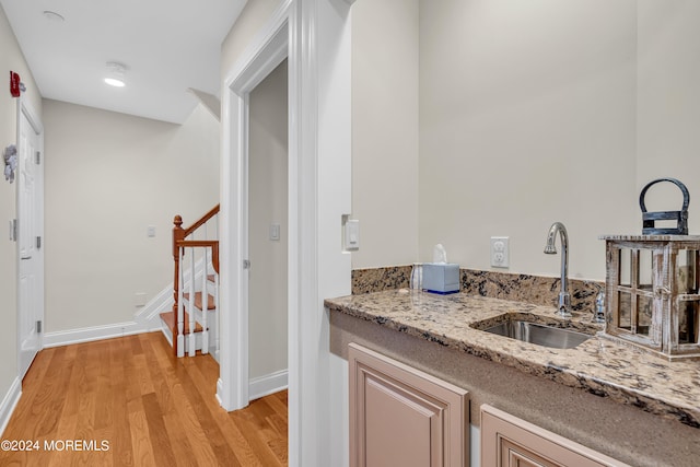 bathroom with hardwood / wood-style floors and sink