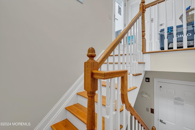 stairs with hardwood / wood-style flooring