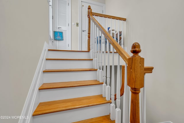 stairs featuring hardwood / wood-style flooring