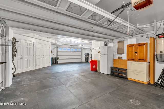 garage with a garage door opener, electric panel, and white refrigerator