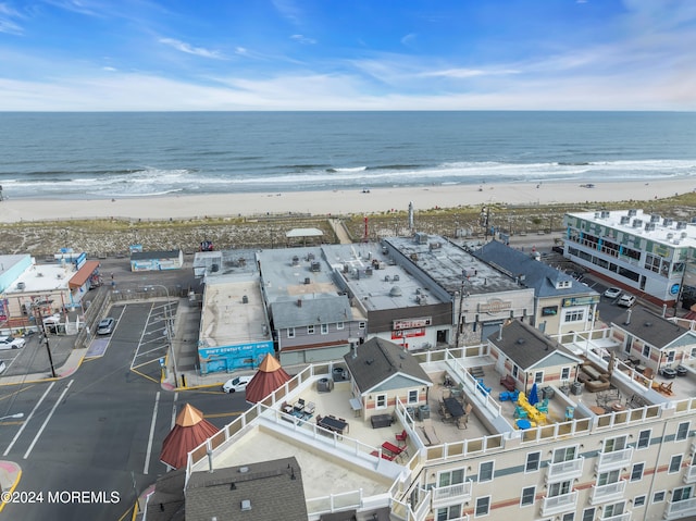 drone / aerial view with a beach view and a water view