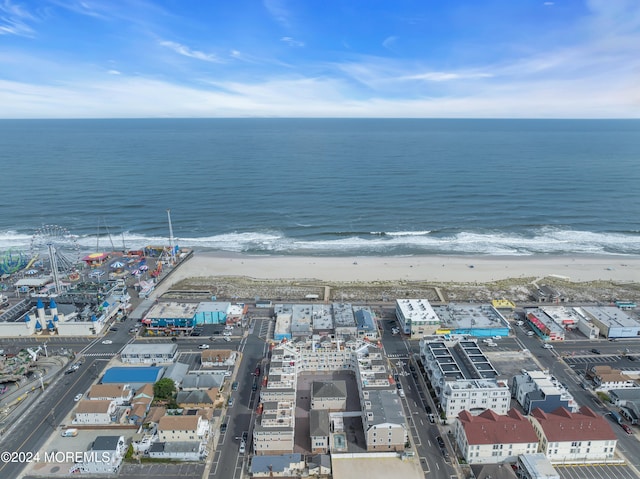 bird's eye view with a water view and a beach view