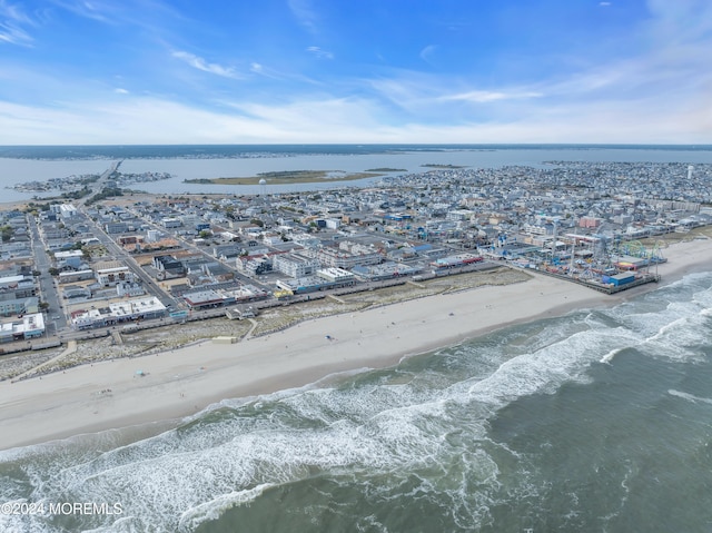 bird's eye view featuring a view of the beach and a water view