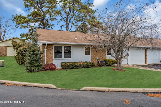 view of front of home featuring a garage and a front yard