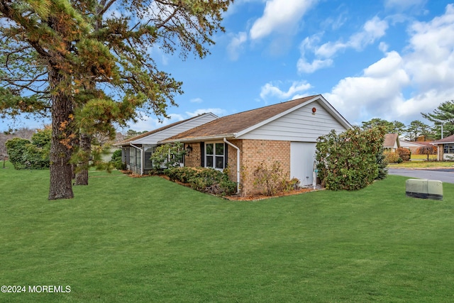 view of side of home featuring a yard