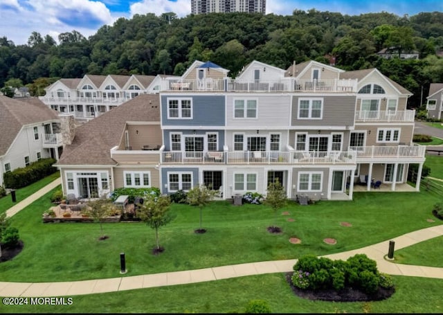 exterior space with a balcony and a yard