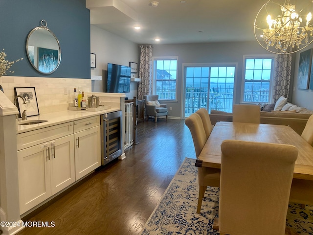 dining room featuring wine cooler, dark wood-type flooring, and sink