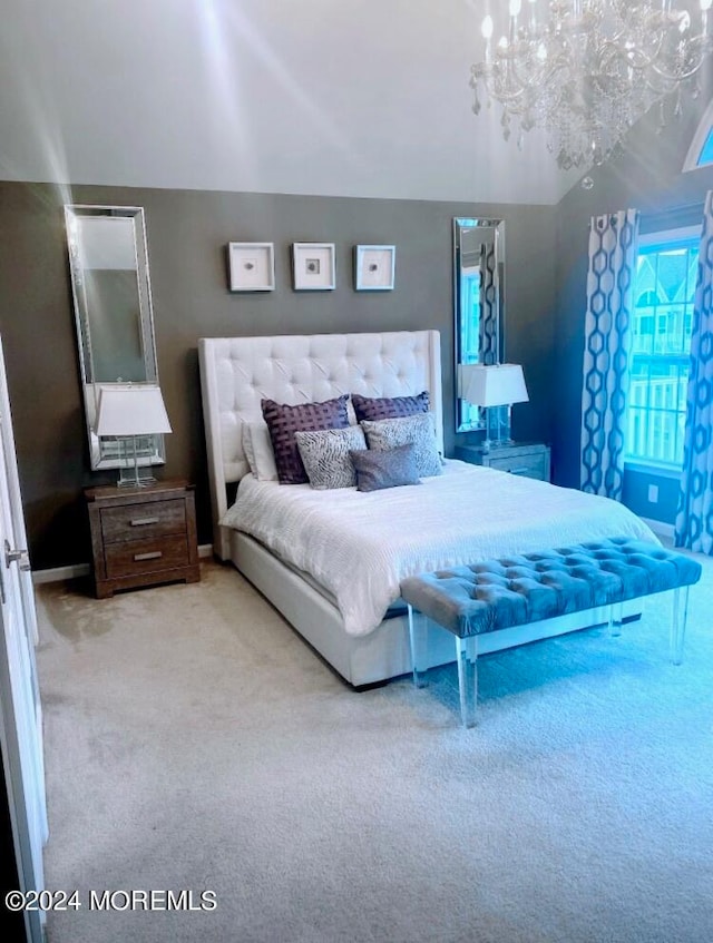 bedroom featuring a notable chandelier and carpet floors