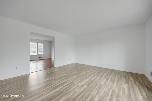 unfurnished room with light hardwood / wood-style flooring