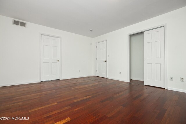 unfurnished bedroom featuring dark hardwood / wood-style floors