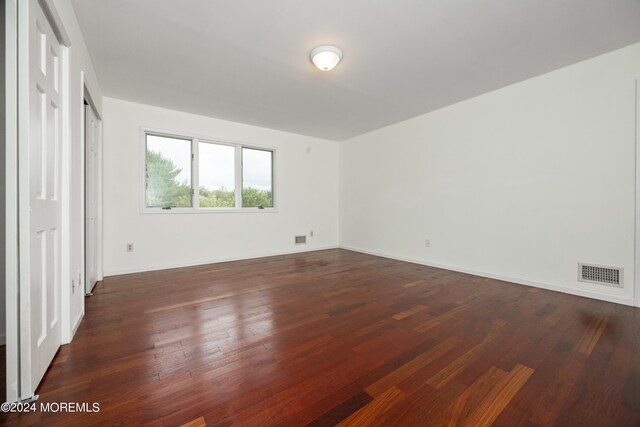 unfurnished bedroom featuring dark wood-type flooring