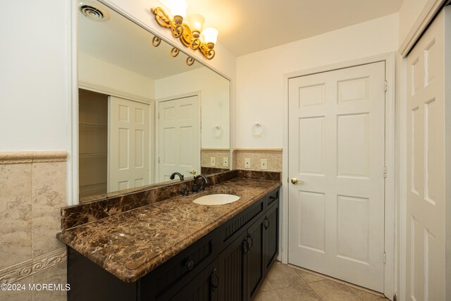 bathroom featuring vanity, tile walls, and tile patterned flooring