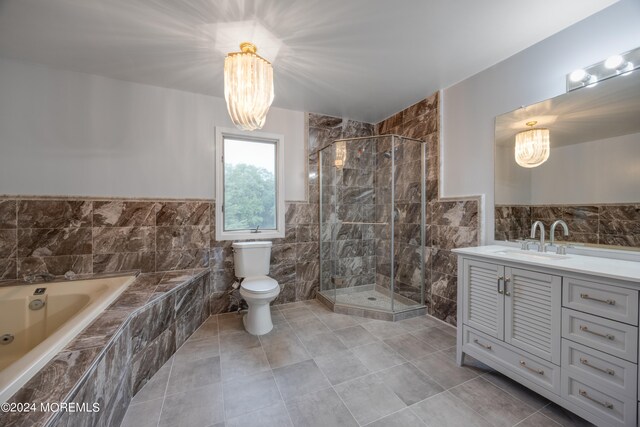 full bathroom with tile walls, vanity, toilet, and plus walk in shower