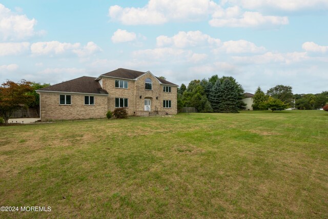 back of property featuring a yard