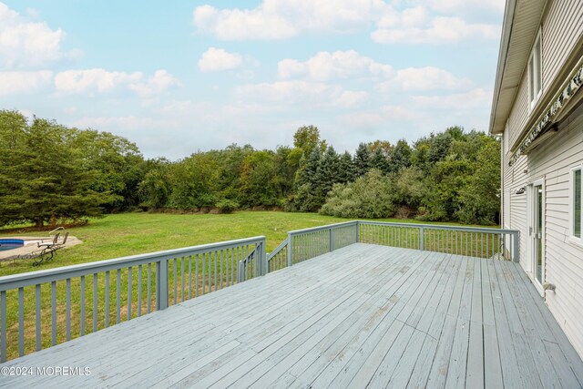 wooden terrace with a yard