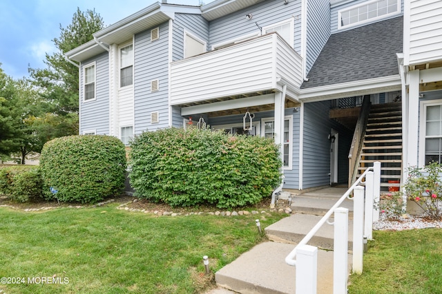 view of side of home featuring a lawn