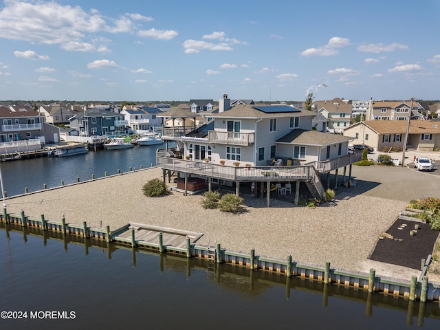 back of house with a deck with water view